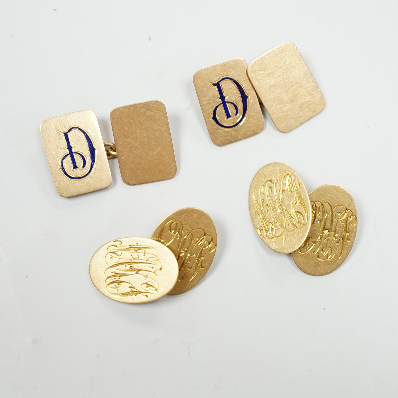 A pair of 18ct gold rectangular cufflinks, with enamelled initial N, 8.2 grams, and a pair of 18ct gold monogrammed oval cufflinks, 8 grams